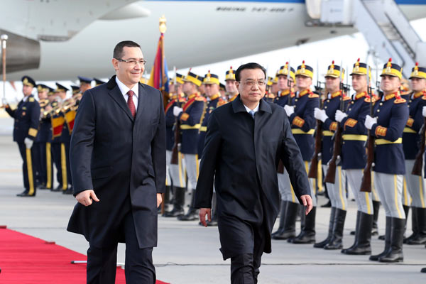 Premier Li Keqiang attends a welcoming ceremony with his Romanian counterpart Victor Ponta on his arrival at Bucharest airport in the Romanian capital on Monday. YAO DAWEI / XINHUA China, Romania seal deals