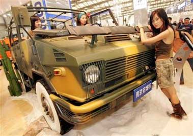 In a file photo models pose next Nanjing IVECO Motors' NJ2046sDG5 4x4 car on display Wednesday April 27, 2005 at Auto Shanghai 2005 exhibition in Shanghai, China. Industrywide, sales of passenger vehicles in China rose 15.7 percent in April over last year's numbers, as car buyers returned to the market after hanging back earlier in the year in hopes of further price cuts, according to the China Automobile Manufacturers Association. (AP