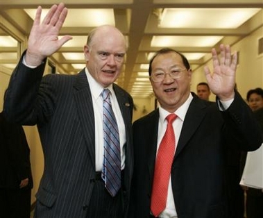 China's Finance Minister Jin Renqing, right, is welcomed by U.S. Treasury Secretary John Snow for private talks at International Monetary Fund Headquarters in Washington, Saturday, Sept. 24, 2005.