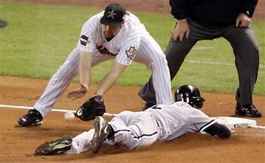 Chicago White Sox's Scott Podsednik slides into third with a triple against Houston Astros pitcher Brandon Backe in the third inning of Game 4 of the World Series Wednesday, Oct. 26, 2005 in Houston. At third waiting for the late throw is Astros third baseman Morgan Ensberg.