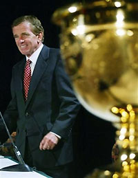 PGA Tour Commissioner Tim Finchem stands next to the President's Cup in Montreal on, Aug. 15, 2005, after announcing that the 2007 President's Cup will be held at the Royal Montreal Golf Club, North America's oldest club.