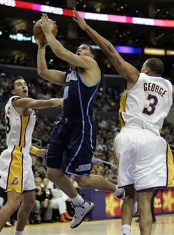 Utah Jazz's Deron Williams, center, shoots over the outstretched arms of Los Angeles Lakers' Devean George, right, and Sasha Vujacic of Slovenia, left, in the first half on NBA basketball game in Los Angeles on Sunday, Jan. 1, 2006.