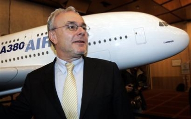 Airbus CEO Germany's Gustav Humbert poses next to a model of an Airbus A380 after a press conference in Paris, Tuesday, Jan. 17, 2006.