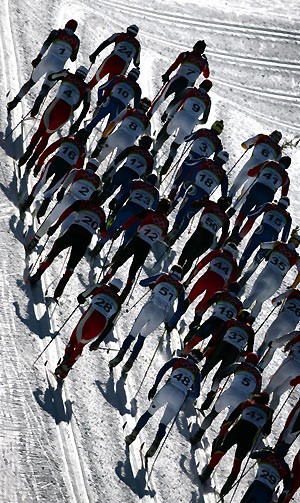 Athletes compete in the men's 30km pursuit cross country race at the Torino 2006 Winter Olympic Games in Pragelato, Italy, February 12, 2006. Russia's Eugen Dementiev won the race ahead of Norway's Frode Estil and Italy's Pietro Piller Cottrer.