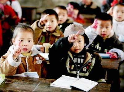 Chinese children attend a class at a primary school in China's rural Panghai town, Guizhou Province March 1, 2006. Spending on education is expected to take up a record 4 per cent of China's gross domestic product (GDP) during the coming five years, China Daily reported.