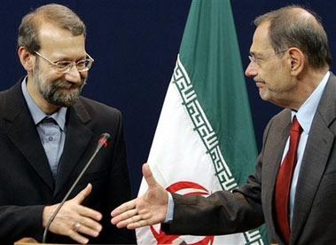 EU foreign policy chief Javier Solana, right, shakes hands with Iran's top nuclear negotiator Ali Larijani at the European Council headquarters after a bilateral meeting in Brussels, Tuesday July 11, 2006. Larijani warned Tuesday that talks on his country's atomic program will be a 'long process,' urging patience and dashing hopes of a breakthrough on the international standoff. (AP Photo/Yves Logghe)